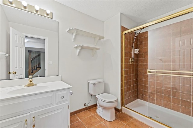 12324 S Clinton St, Olathe, KS 66061 - bathroom featuring a shower stall, vanity, tile patterned floors, and a textured ceiling