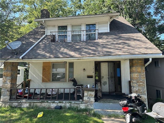 1814 E 48th St, Kansas City, MO 64130 - view of front of property with roof with shingles, stone siding, and a chimney