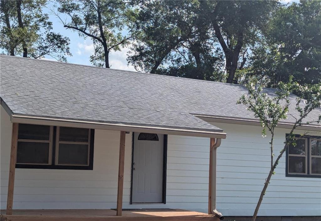 925 E 21st Ter, Lawrence, KS 66046 - exterior view of a downspout, a shingled roof, and gutters