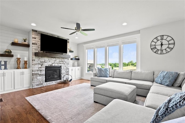 2312 SW Morris Dr, Lees Summit, MO 64082 - living room with wood finished floors, a ceiling fan, a stone fireplace, and recessed lighting