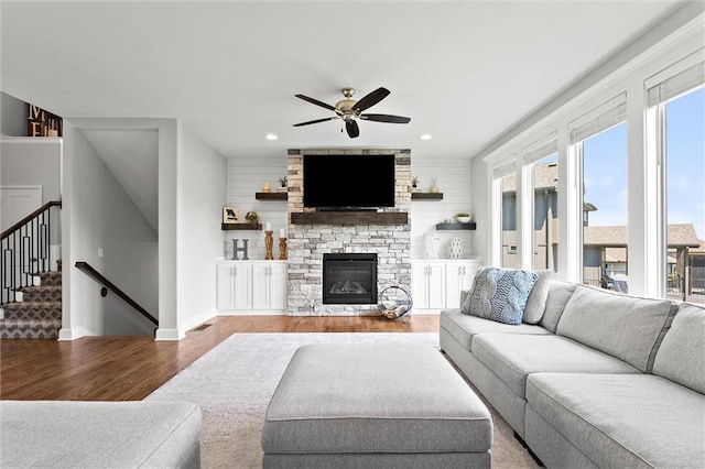 2312 SW Morris Dr, Lees Summit, MO 64082 - living area featuring wood finished floors, ceiling fan, a fireplace, recessed lighting, and stairway