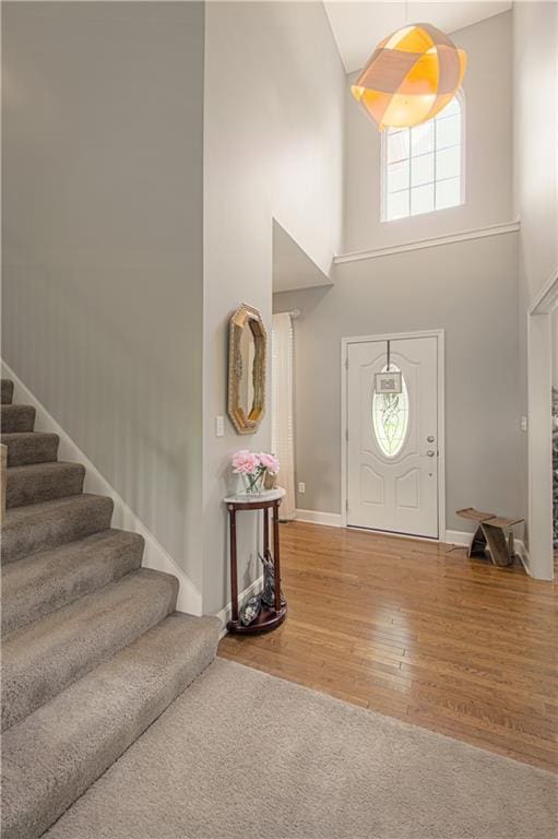 908 Pca Rd, Warrensburg, MO 64093 - entryway featuring a high ceiling, stairs, and wood finished floors