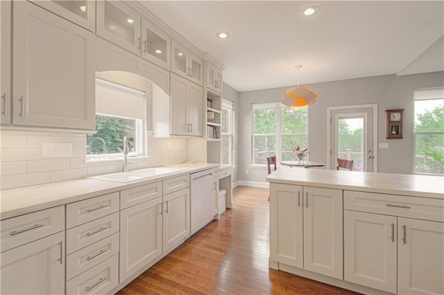 908 Pca Rd, Warrensburg, MO 64093 - kitchen featuring white dishwasher, light wood-style flooring, recessed lighting, white cabinetry, and decorative backsplash