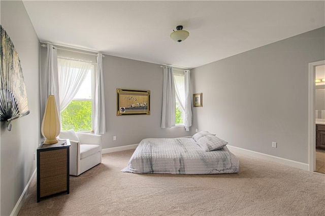 908 Pca Rd, Warrensburg, MO 64093 - carpeted bedroom featuring baseboards and ensuite bath