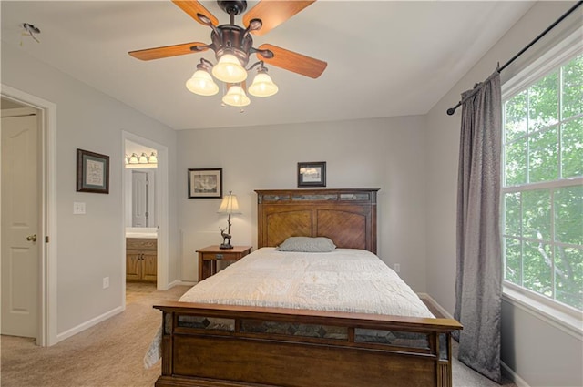 908 Pca Rd, Warrensburg, MO 64093 - bedroom featuring light carpet, multiple windows, connected bathroom, and ceiling fan