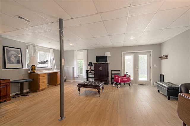 908 Pca Rd, Warrensburg, MO 64093 - living area featuring a drop ceiling, light wood finished floors, and plenty of natural light