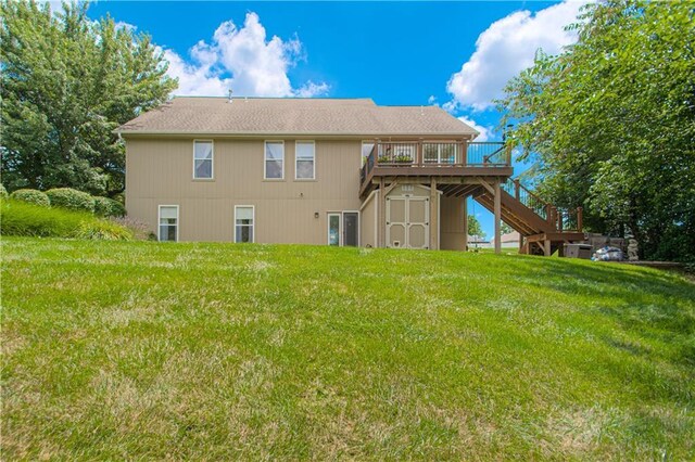 908 Pca Rd, Warrensburg, MO 64093 - rear view of property featuring stairway, a deck, a storage unit, and a lawn