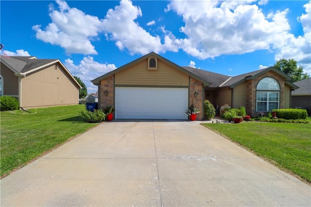 329 W 26th Ln, Eudora, KS 66025 - view of front of house featuring a garage, concrete driveway, and a front lawn