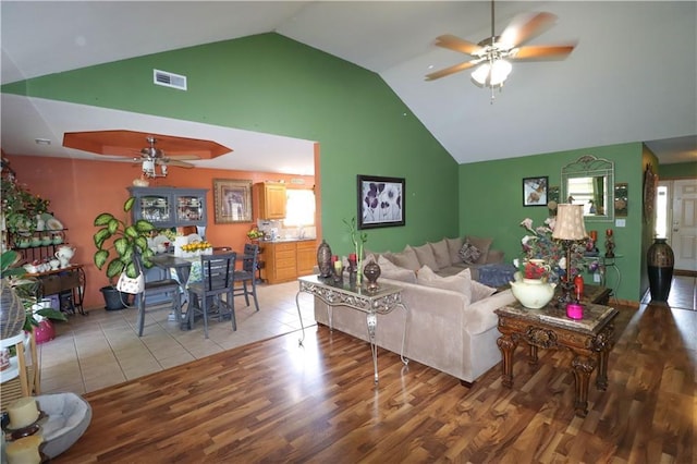 329 W 26th Ln, Eudora, KS 66025 - living area featuring a ceiling fan, high vaulted ceiling, and wood finished floors