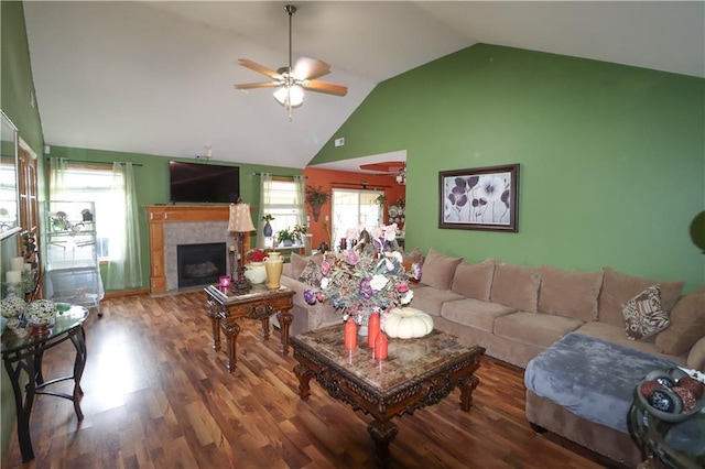 329 W 26th Ln, Eudora, KS 66025 - living area with a ceiling fan, lofted ceiling, a tiled fireplace, and wood finished floors