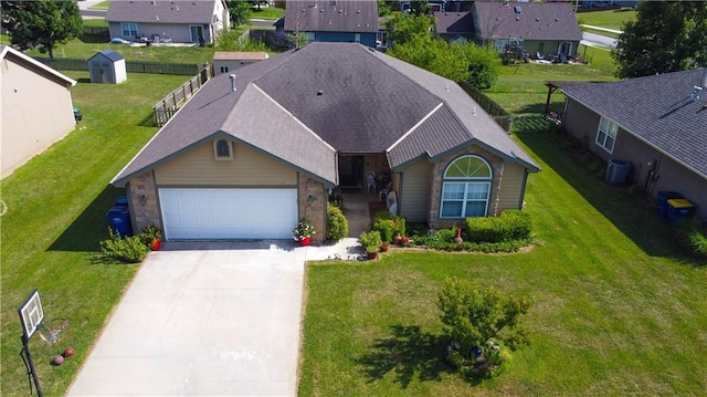 329 W 26th Ln, Eudora, KS 66025 - ranch-style house with concrete driveway, a garage, a residential view, a shingled roof, and a front lawn