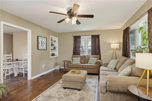 1304 S 39th St, Saint Joseph, MO 64507 - living room featuring a ceiling fan and dark wood finished floors