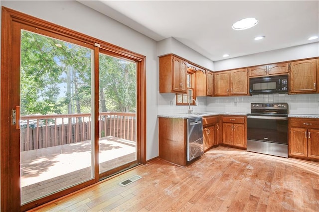 12303 W 105th Ter, Overland Park, KS 66215 - kitchen featuring stainless steel appliances, light wood-type flooring, backsplash, brown cabinetry, and recessed lighting