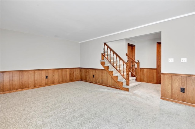 12303 W 105th Ter, Overland Park, KS 66215 - carpeted empty room with stairs, wainscoting, and wood walls