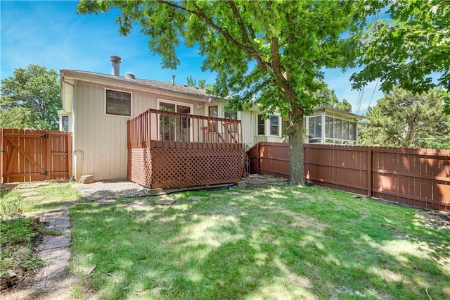 12303 W 105th Ter, Overland Park, KS 66215 - back of property with a fenced backyard, a sunroom, a wooden deck, and a gate