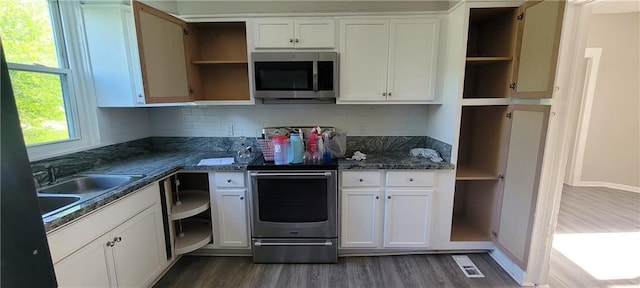 5107 E 26th St, Kansas City, MO 64127 - kitchen with open shelves, stainless steel appliances, dark wood finished floors, and white cabinets
