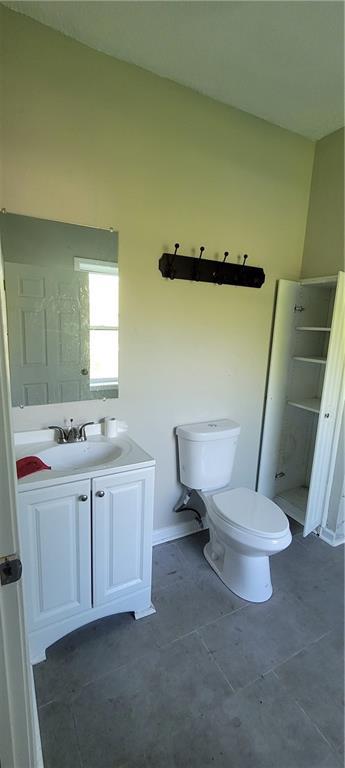5107 E 26th St, Kansas City, MO 64127 - bathroom with vanity and tile patterned floors