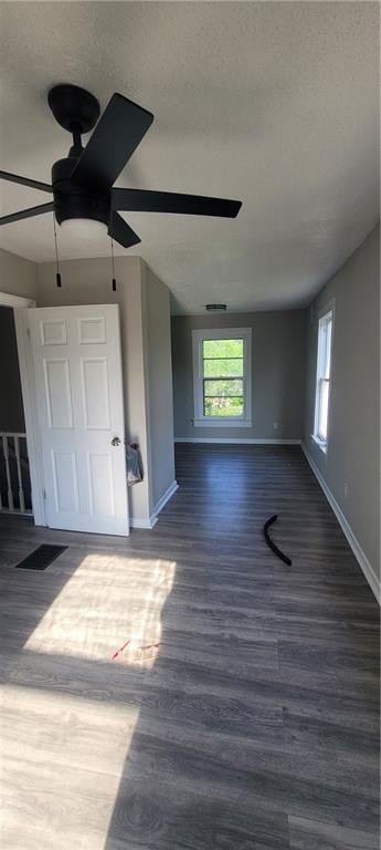 5107 E 26th St, Kansas City, MO 64127 - unfurnished bedroom featuring wood finished floors and ceiling fan
