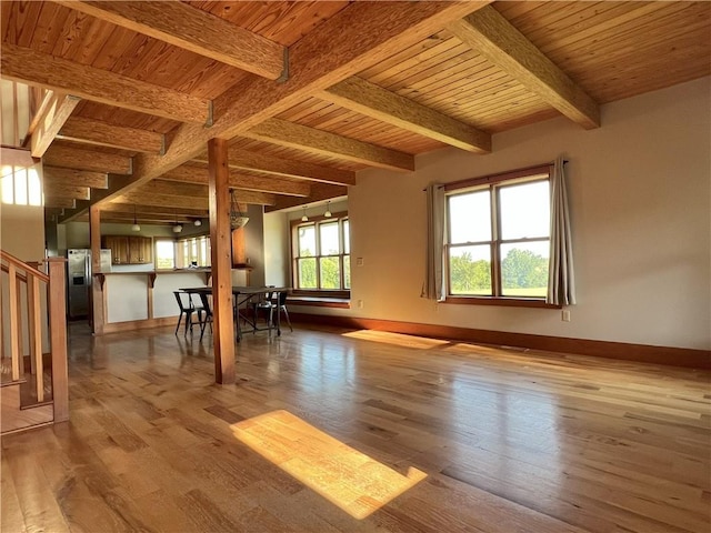 11320 Reno Rd, Oskaloosa, KS 66066 - unfurnished living room featuring wood finished floors, stairs, and a wooden ceiling with exposed beams