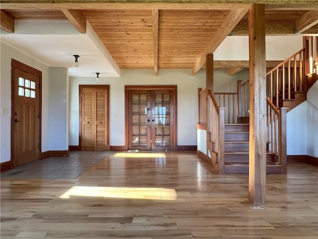 11320 Reno Rd, Oskaloosa, KS 66066 - foyer featuring stairway, wood finished floors, a wood ceiling with exposed beams, and french doors