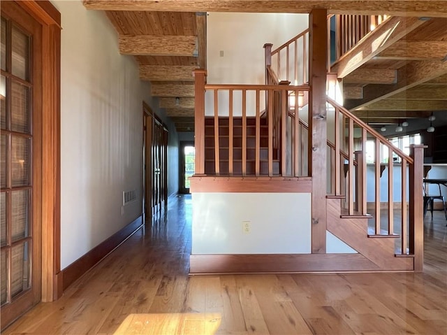 11320 Reno Rd, Oskaloosa, KS 66066 - stairway featuring wood-type flooring and a wood ceiling with exposed beams