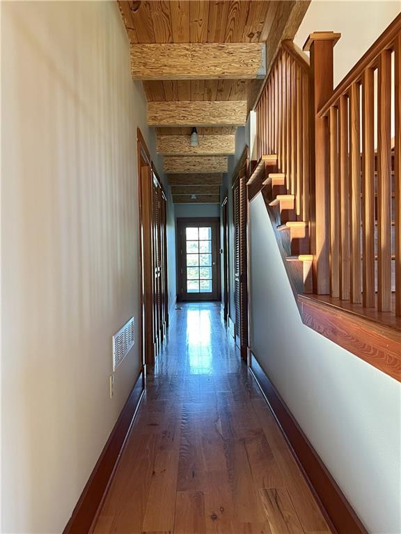 11320 Reno Rd, Oskaloosa, KS 66066 - corridor with dark wood-type flooring, a wood ceiling with exposed beams, and stairs