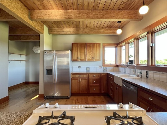 11320 Reno Rd, Oskaloosa, KS 66066 - kitchen featuring appliances with stainless steel finishes, a wood ceiling with exposed beams, light wood-type flooring, brown cabinets, and plenty of natural light