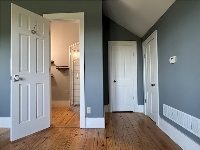 11320 Reno Rd, Oskaloosa, KS 66066 - unfurnished bedroom with hardwood / wood-style floors, lofted ceiling, connected bathroom, and a closet