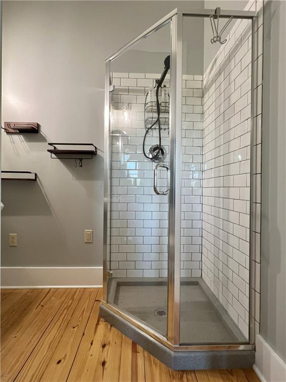 11320 Reno Rd, Oskaloosa, KS 66066 - full bathroom featuring a shower stall and wood finished floors