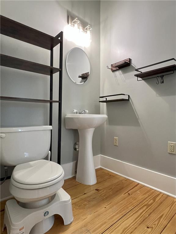 11320 Reno Rd, Oskaloosa, KS 66066 - bathroom with toilet and wood finished floors