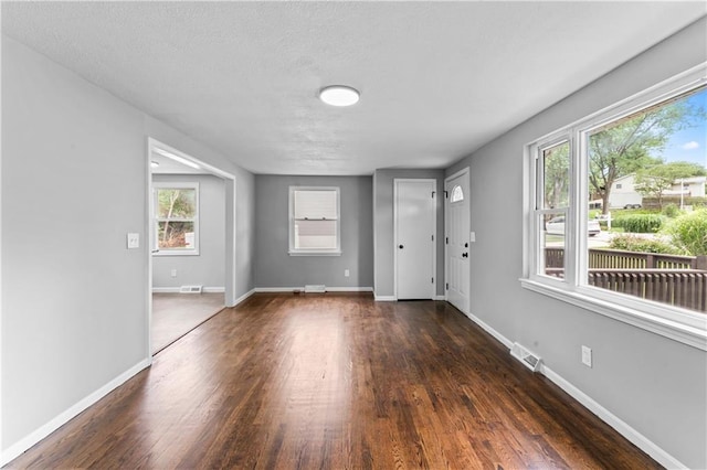 26 Misty Springs Cir, Platte City, MO 64079 - foyer entrance featuring wood finished floors, healthy amount of natural light, and a textured ceiling