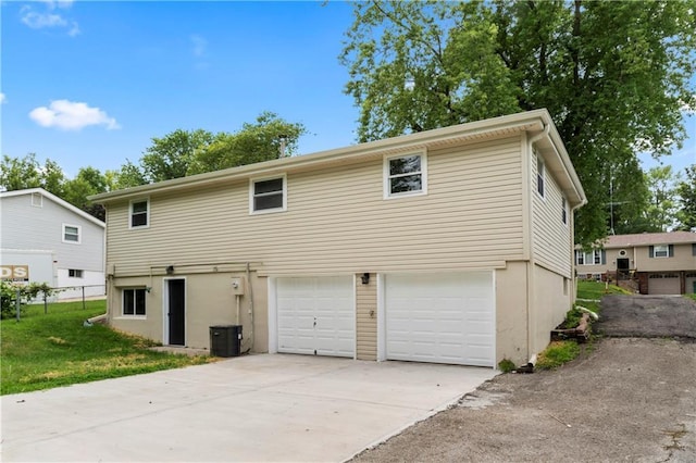 26 Misty Springs Cir, Platte City, MO 64079 - back of property featuring a garage, concrete driveway, and stucco siding
