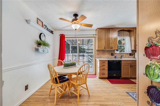 300 NE R D Mize Rd, Blue Springs, MO 64014 - dining room featuring light wood finished floors, ceiling fan, a textured ceiling, and plenty of natural light