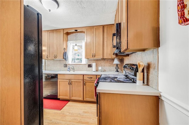 300 NE R D Mize Rd, Blue Springs, MO 64014 - kitchen with black appliances, light wood-style floors, backsplash, light countertops, and a textured ceiling