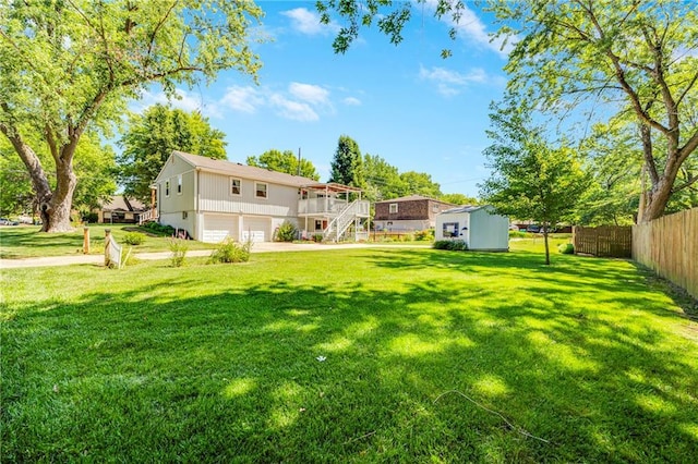 300 NE R D Mize Rd, Blue Springs, MO 64014 - view of yard with an attached garage, stairs, a shed, and a deck