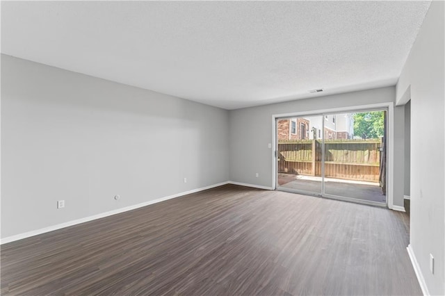 10240 W 96th Ter Unit B, Overland Park, KS 66212 - unfurnished room with dark wood-style floors and a textured ceiling