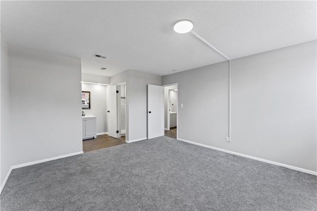 10240 W 96th Ter Unit B, Overland Park, KS 66212 - unfurnished bedroom with dark colored carpet, a textured ceiling, and ensuite bathroom