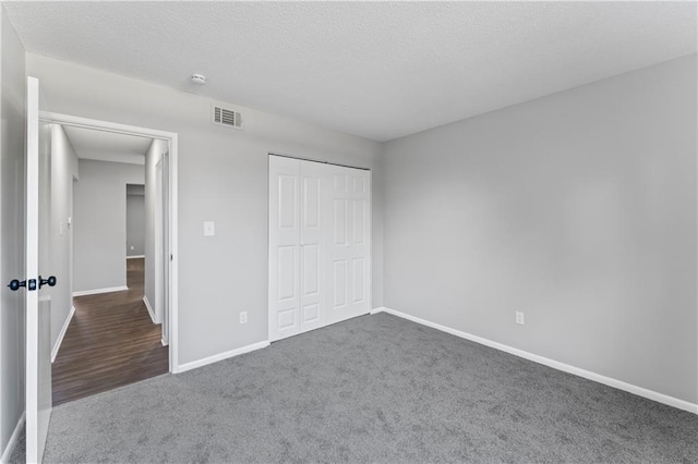 10240 W 96th Ter Unit B, Overland Park, KS 66212 - unfurnished bedroom with carpet flooring, a closet, and a textured ceiling