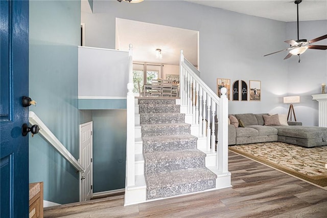 10512 Shelton Ave, Edwardsville, KS 66111 - staircase featuring wood finished floors and a ceiling fan