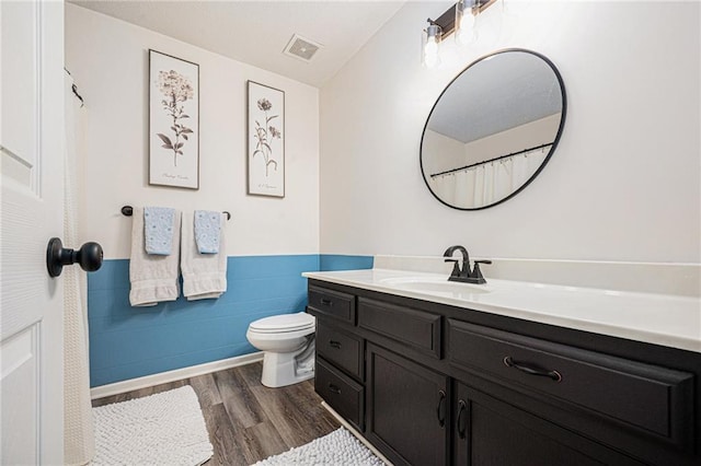10512 Shelton Ave, Edwardsville, KS 66111 - bathroom with vanity, wood finished floors, and a wainscoted wall