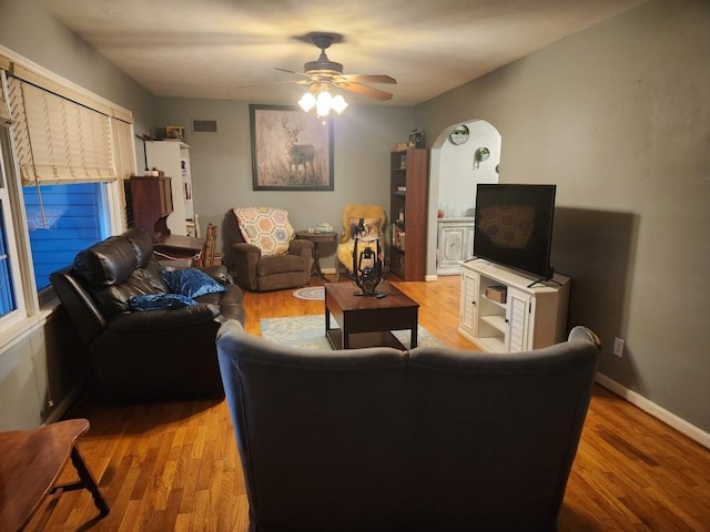 520 S Russell St, Odessa, MO 64076 - living area with light wood-style flooring and ceiling fan