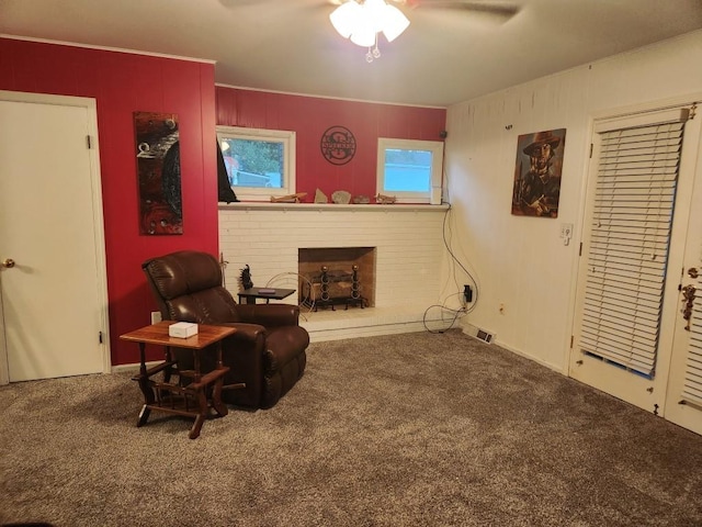520 S Russell St, Odessa, MO 64076 - living area featuring carpet flooring, a fireplace, and a ceiling fan