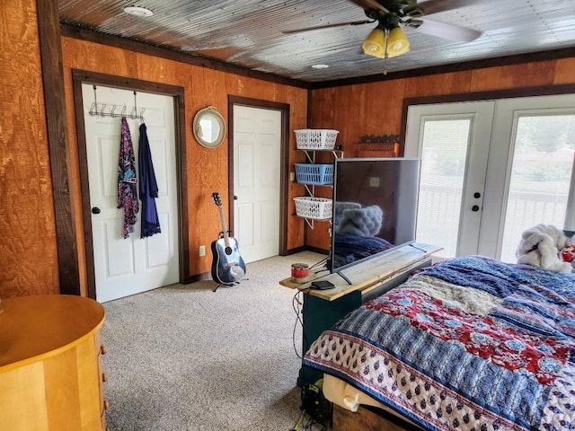 520 S Russell St, Odessa, MO 64076 - bedroom with carpet flooring, french doors, and wood walls