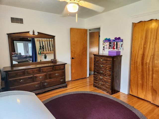 520 S Russell St, Odessa, MO 64076 - bedroom with light wood finished floors and a ceiling fan