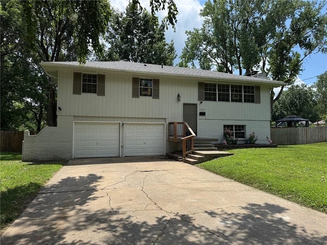 1012 NW A St, Blue Springs, MO 64015 - raised ranch with a garage, driveway, and brick siding