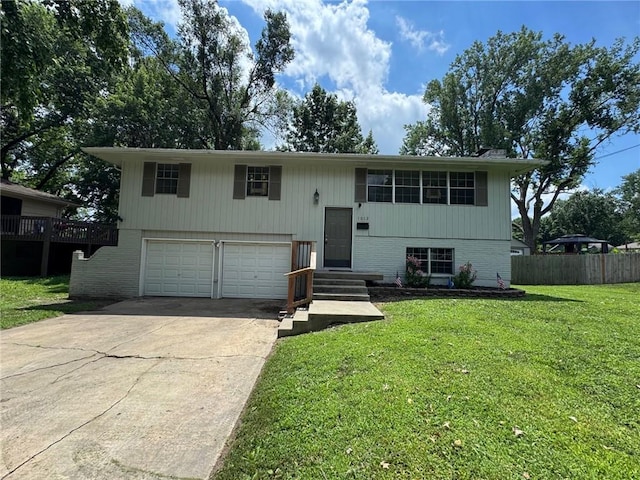 1012 NW A St, Blue Springs, MO 64015 - split foyer home featuring an attached garage, driveway, and brick siding
