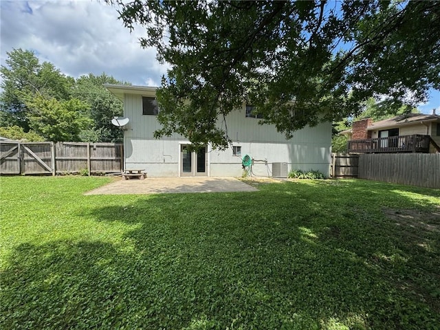 1012 NW A St, Blue Springs, MO 64015 - back of house with a patio, a fenced backyard, and french doors
