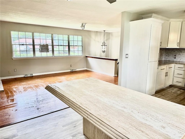 1012 NW A St, Blue Springs, MO 64015 - unfurnished dining area with healthy amount of natural light and wood finished floors