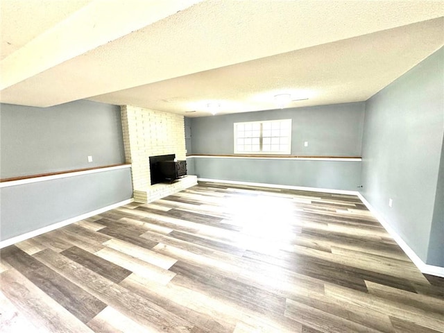 1012 NW A St, Blue Springs, MO 64015 - below grade area with wood finished floors and a textured ceiling