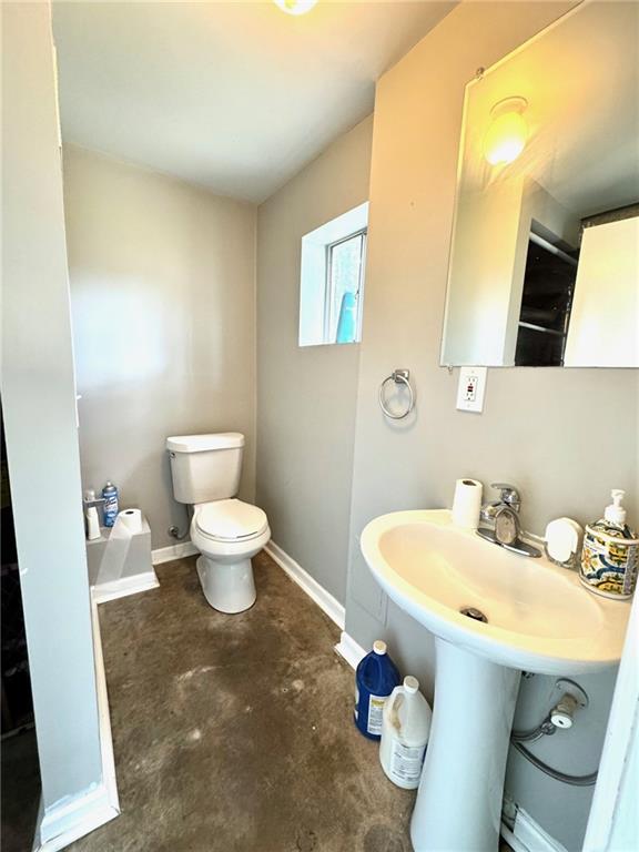 1012 NW A St, Blue Springs, MO 64015 - bathroom featuring toilet and unfinished concrete floors